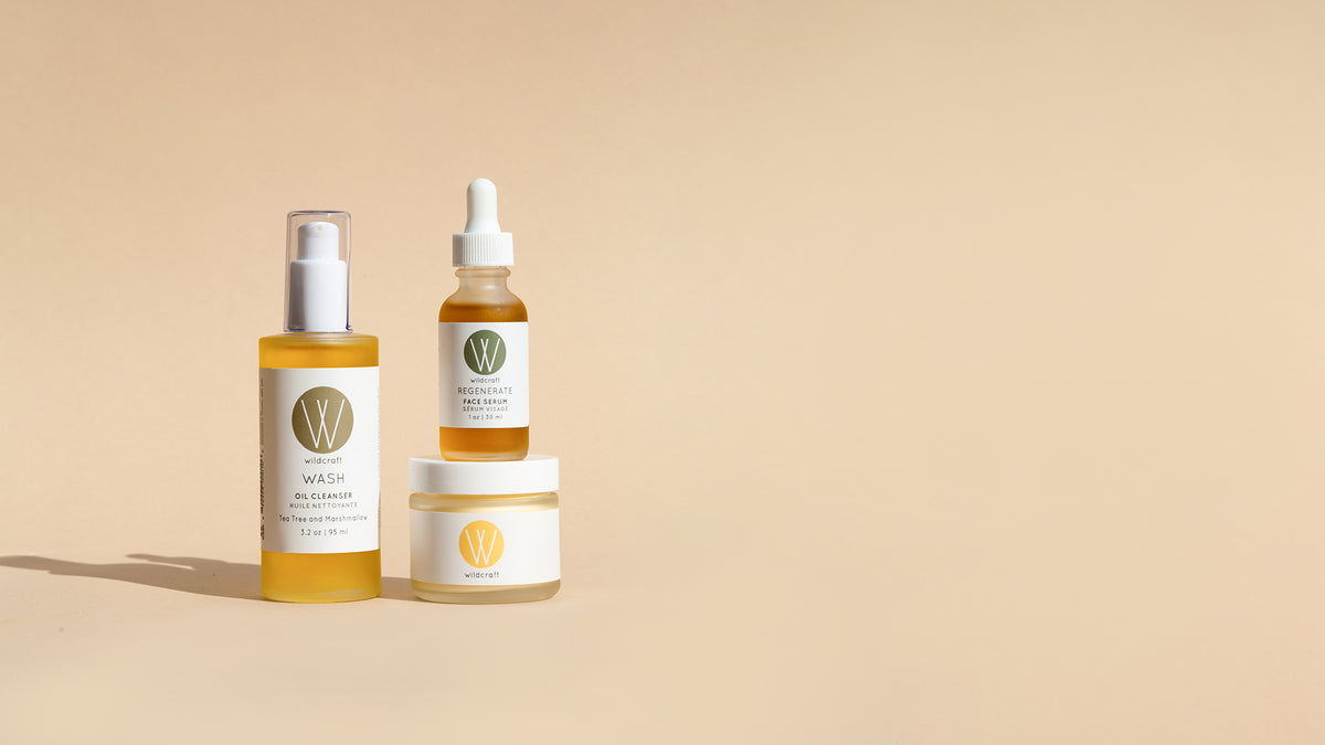 Wildcraft oil cleanser, face serum, and face cream skincare products stacked on top of each other on light backdrop
