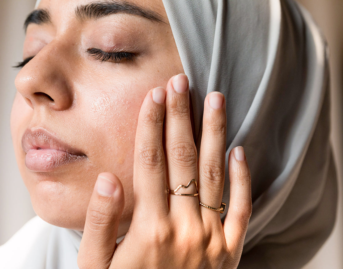 Women with eyes closed and hand on side of her face