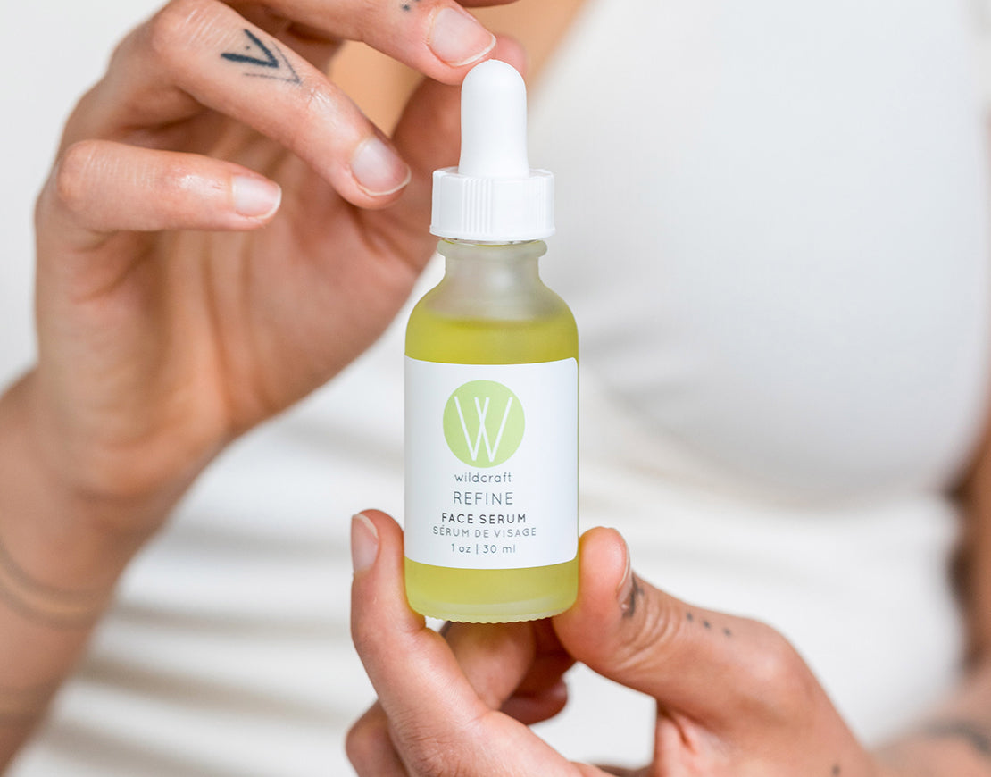 Close up of women holding bottle of Wildcraft refine face serum